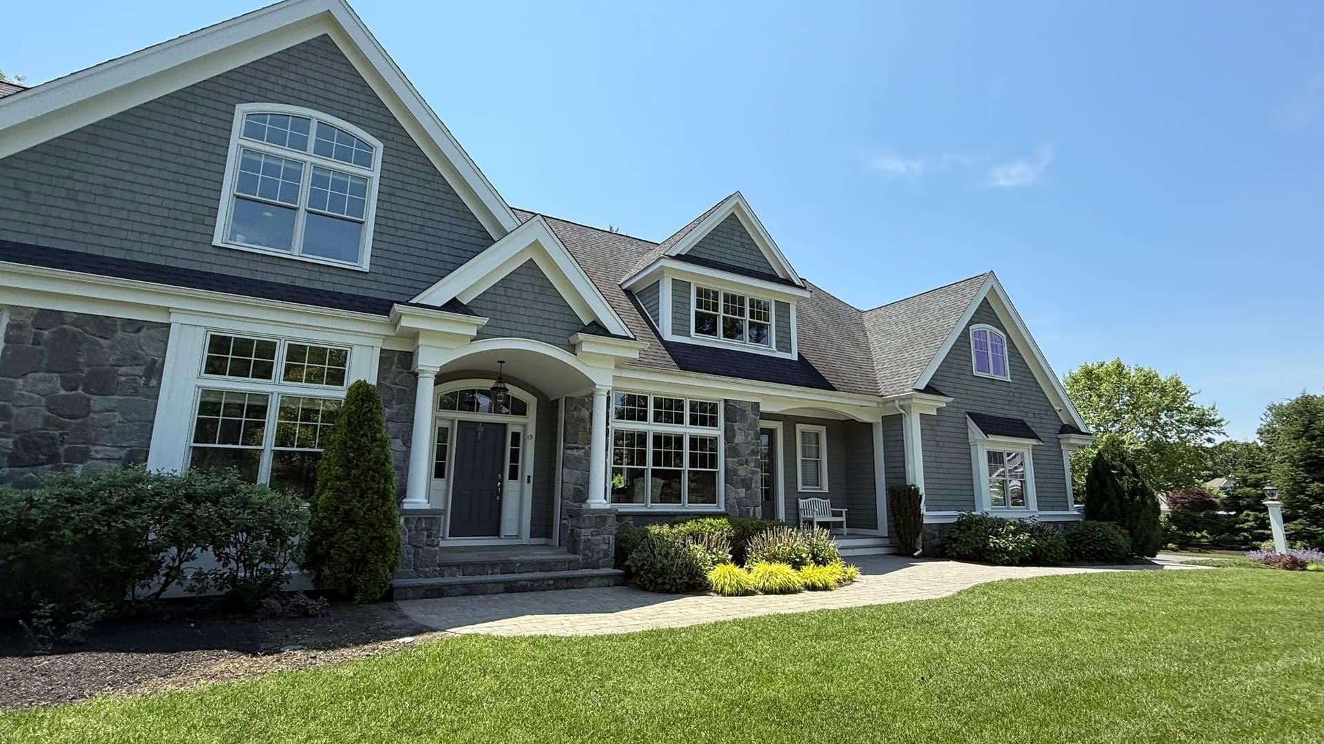 Finished shingle and stone home painted by D & B Painting Inc in MetroWest Massachusetts